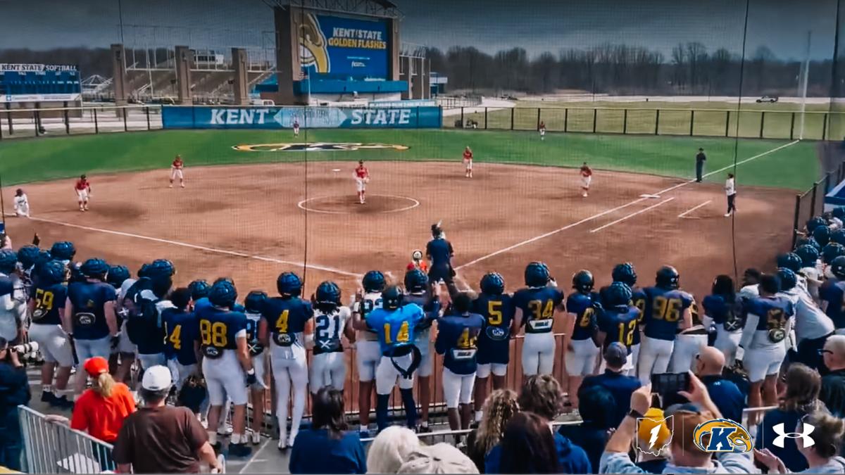 Football team supporting softball team.