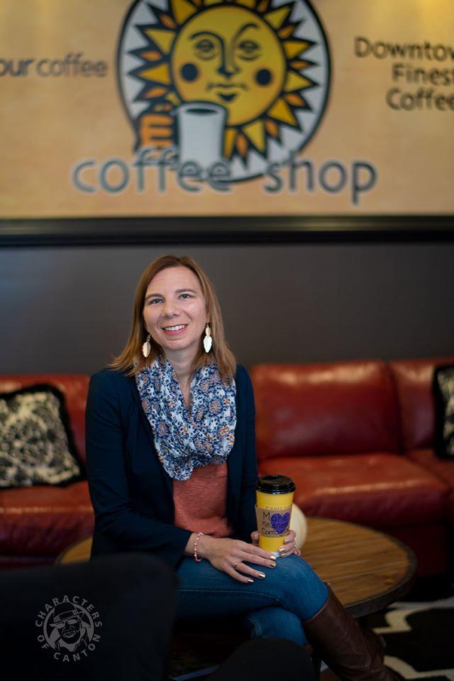 Stephanie Sweany sitting at a coffee shop, smiling for the camera
