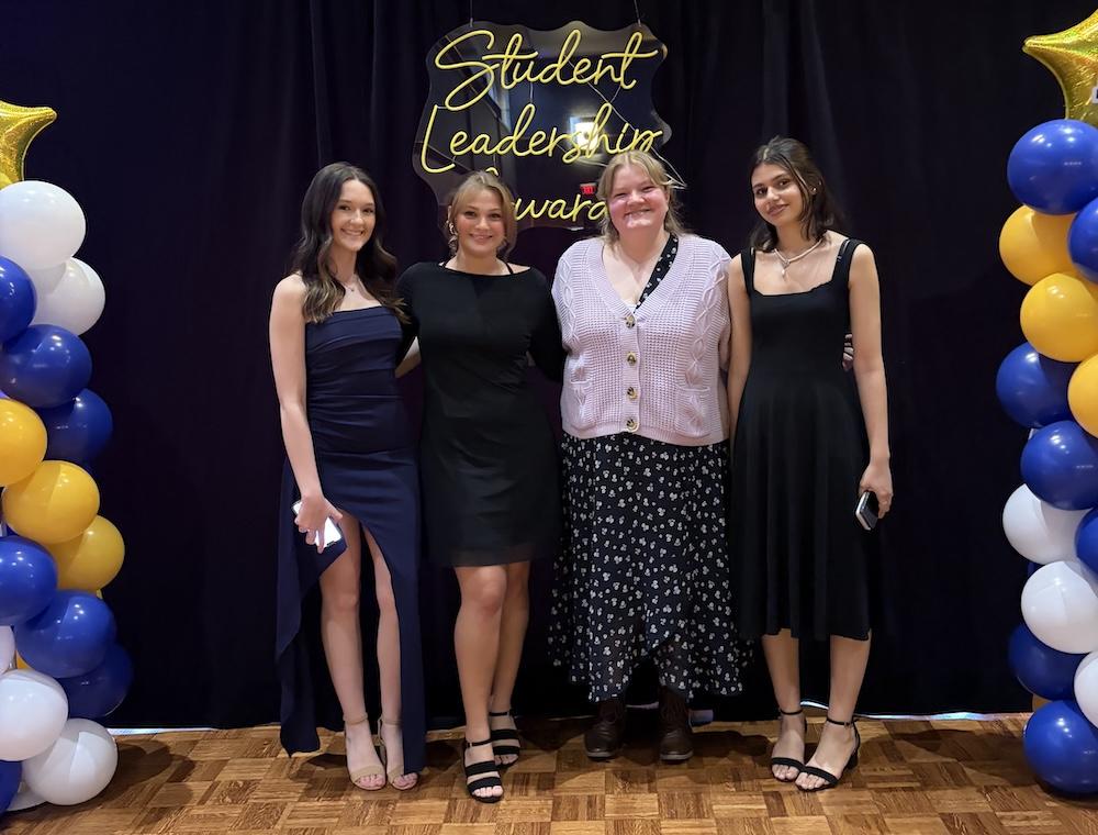 Monica, Lettie, Karissa and Soniya dressed up, posing together at the Student Leadership Awards
