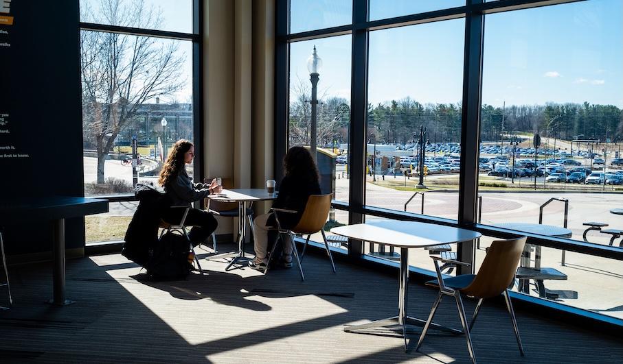 Student sitting in the sun by the window