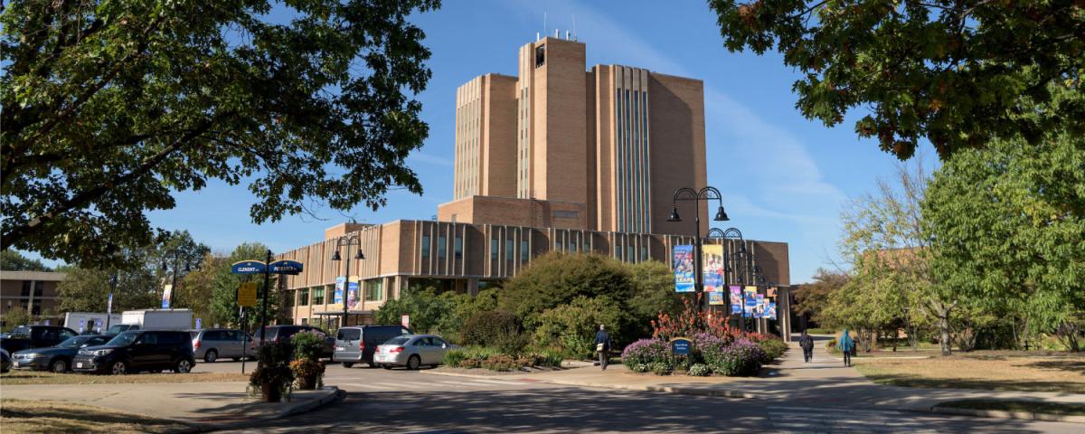 A photo of the Kent State University Library surrounded by trees