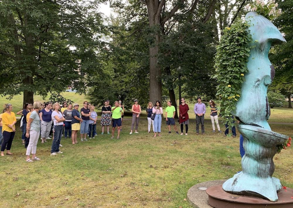 Rebekka Berryhill leading a tour group to the Sidney sculpture. 