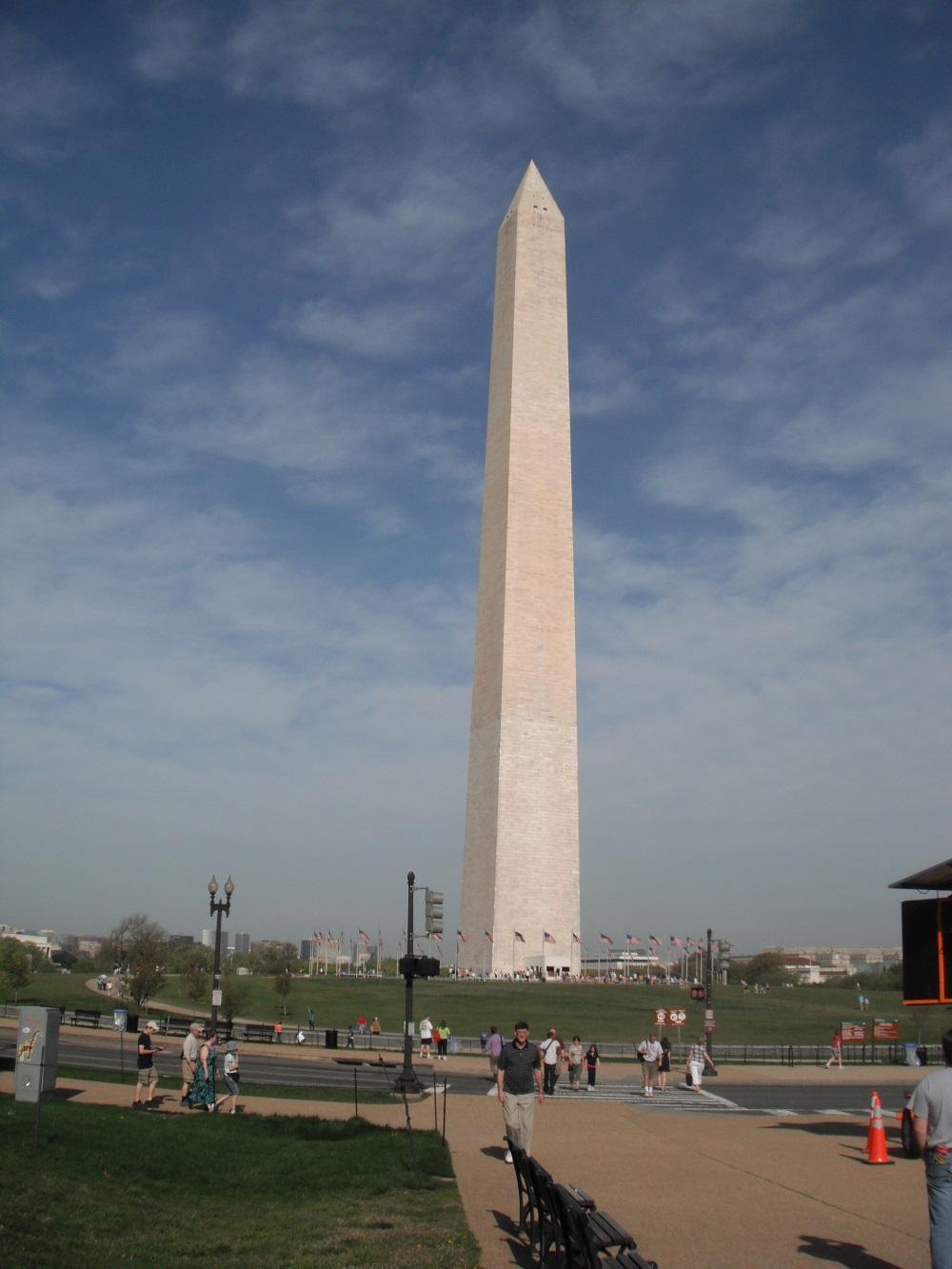 Washington Monument during the day with visitors walking around nearby.
