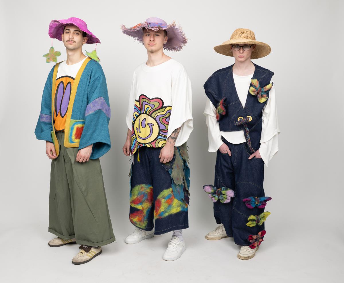 models wear wide-legged pansts with cartoon-like patches on them, along with colorful loose fitted tops and sun hats