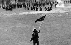 A man waving a flag at the May 4th Protest