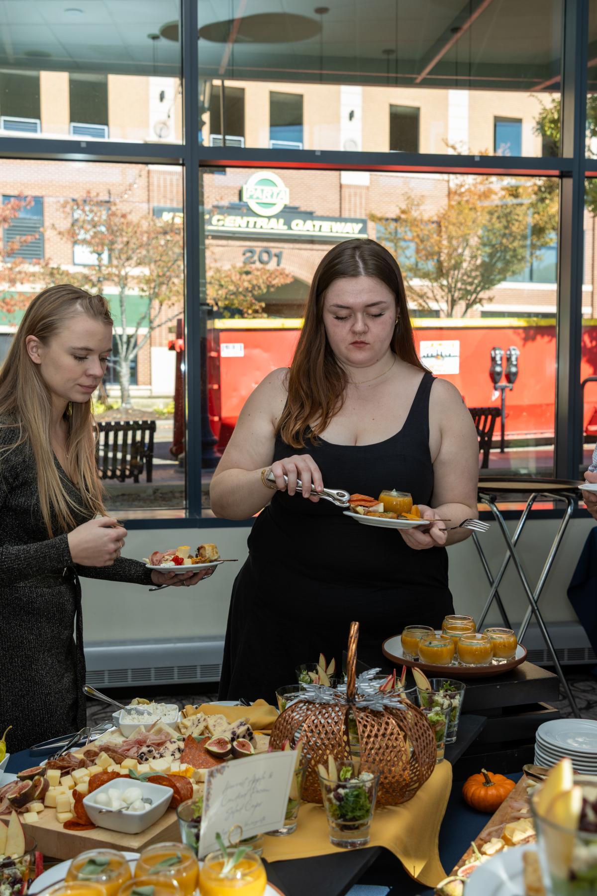 Students enjoying the selection of food at the reception.