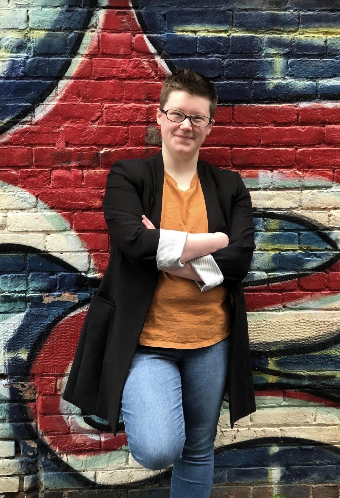 Moira Armstrong posing in front of a wall