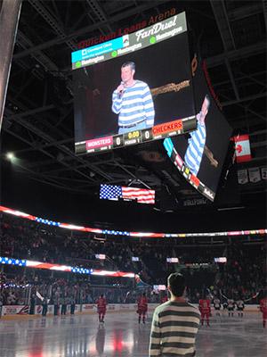 Ridinger singing the National Anthem before a Cleveland Monsters hockey match