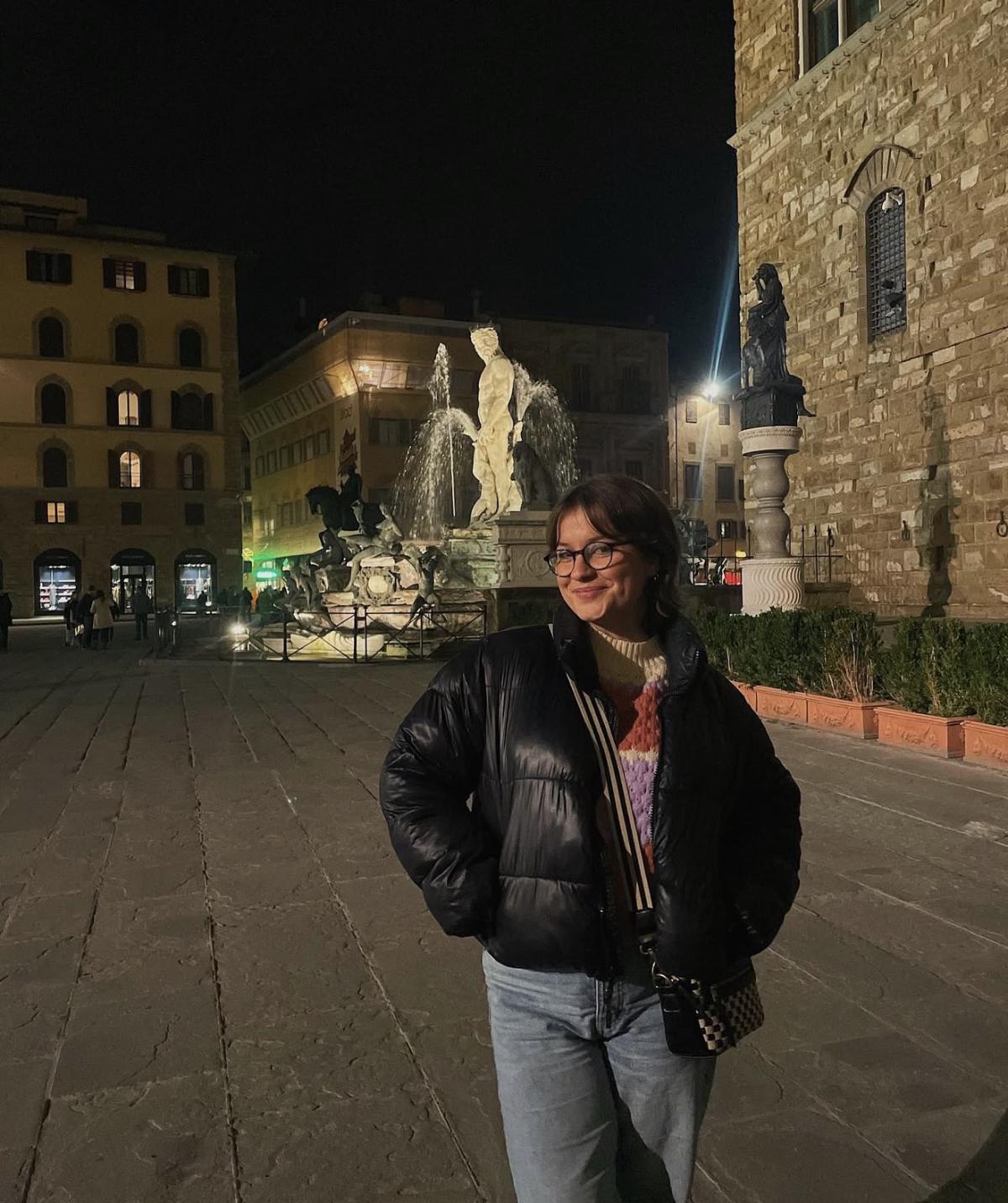 Ali near Palazzo Vecchio in Florence at night.