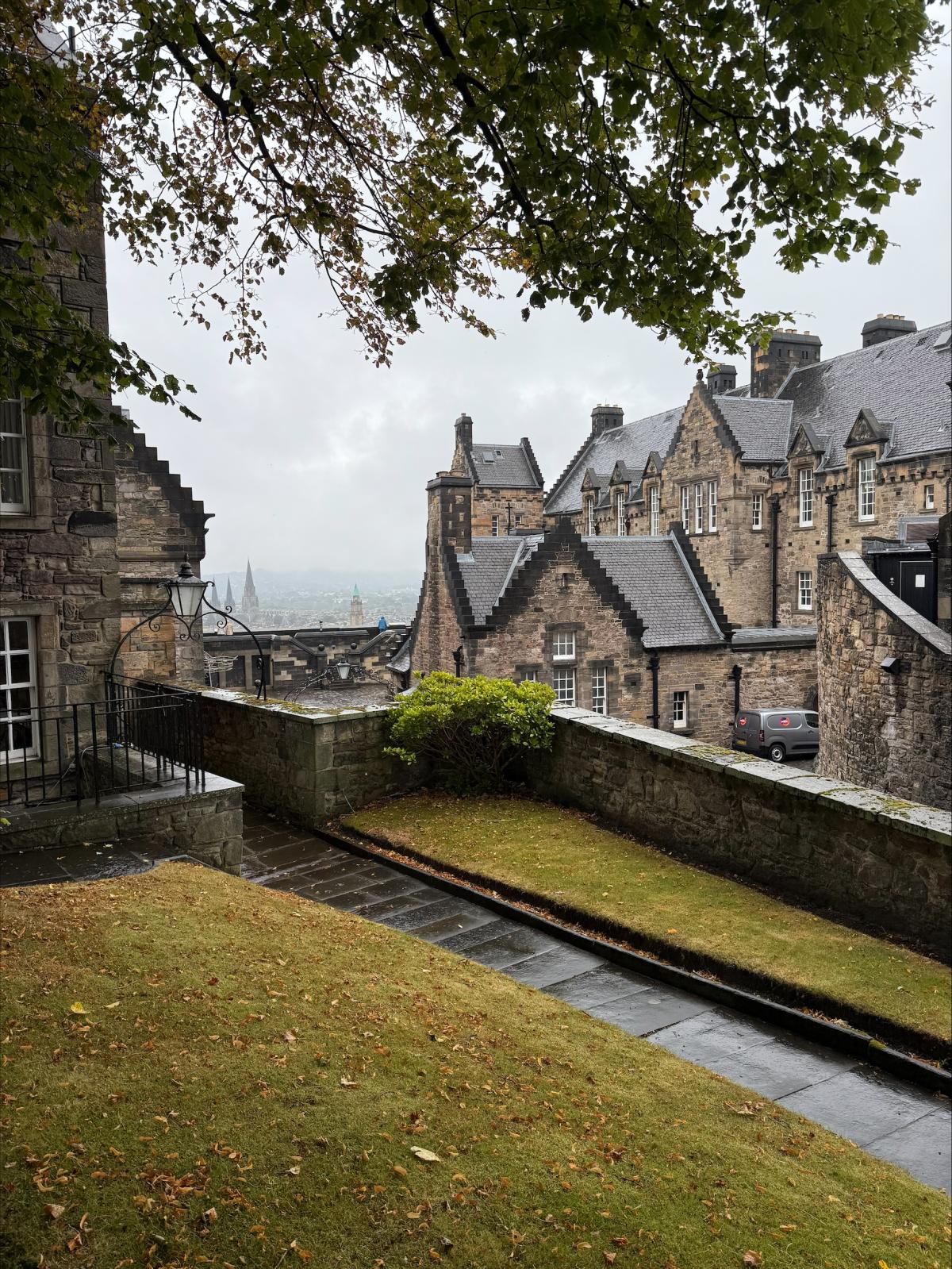 a garden area with views of buildings in the background