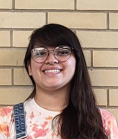 student standing in front of wall