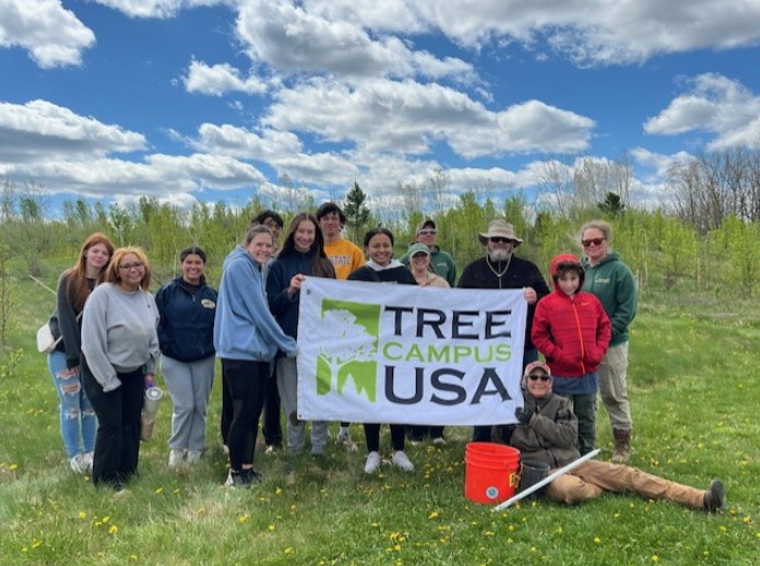 A group of volunteers that just planted trees on campus