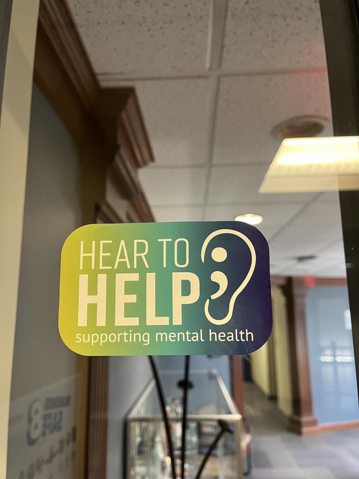 Window Cling states Hear To Help supporting mental health