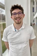 Nathan smiling at camera in Crawford hall