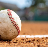 A baseball lies in the dirt