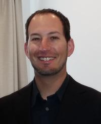 Brian Raitman smiling for a headshot