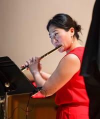 Performing with a flute, red dress