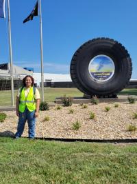 A photo of Guinn standing in front of a Goodyear Tires sign.