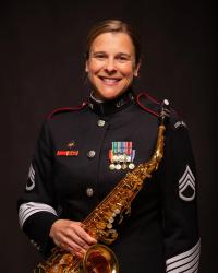 Blonde woman holding saxophone