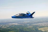 A blue JSX-2 aircraft in flight