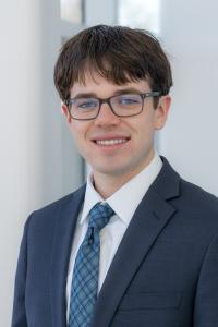 jake marriner power pose in suit.