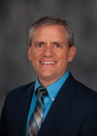Photo of man in suit on gray background