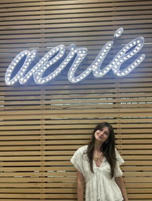 Morgan poses by a Aerie sign.