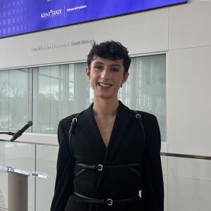 Carter Evans, the Centennial Court A Resident Assistant, wearing a black coat and smiling at the camera