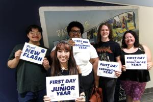 Honey pictured holding a sign that reads "First Day of Sophomore Year".
