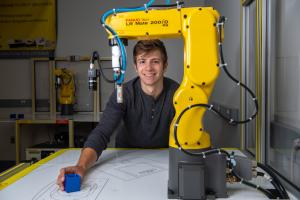 Male Student with FANUC Robot