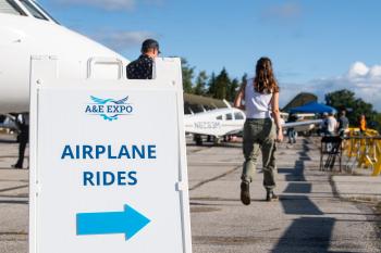 A sign reading "Airplane Rides" points to small planes and people at the Aeronautics & Engineering Expo