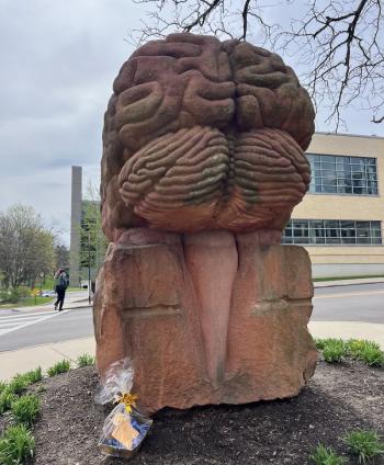 Thank-a-giver scavenger hunt shows gift basket below Brain sculpture