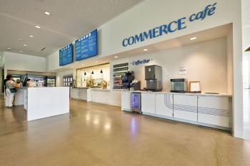 side view of commerce cafe showing people ordering and the coffee and water bars. 