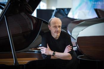 Marc-André Hamelin posing at a piano