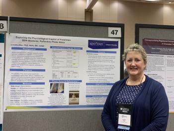 Dr. Loretta Aller with her poster at MNRS