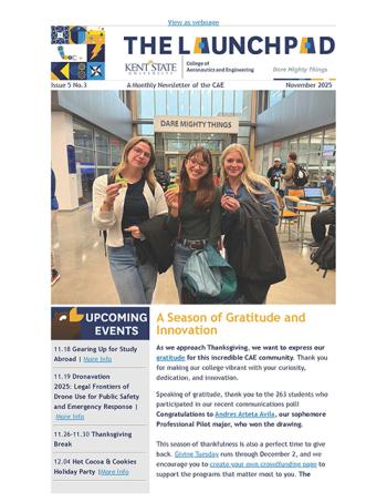 Three female students holding small cakes