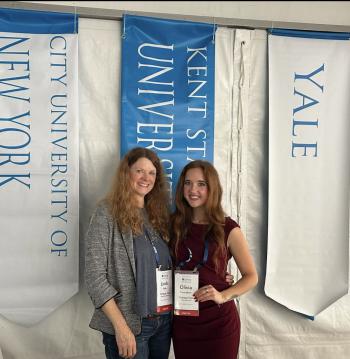 Linda and Olivia pose in front of the 91��Ƭ�� banner at the Rice Business Plan Competition