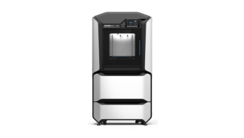 A large 3d printer with a central chamber housed in a large silver cabinet