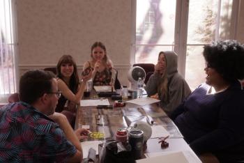 Honey sits at one of her club meetings around a table.