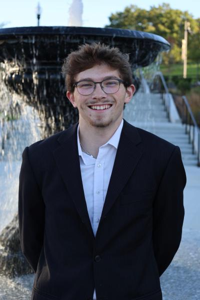 Nathan Smith smiling and standing in front of Crawford Fountain