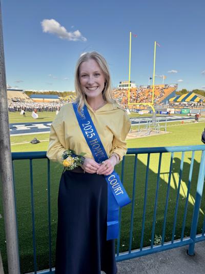 Student Sydney Brown poses in the football stands