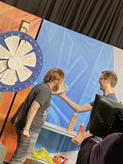 Student shoves pie in the face of another student in game