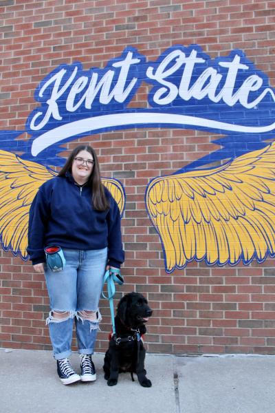 Kennedy in front of a Kent State mural with her dog