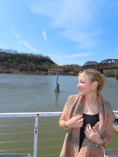 Honors college student poses in front of a body of water.