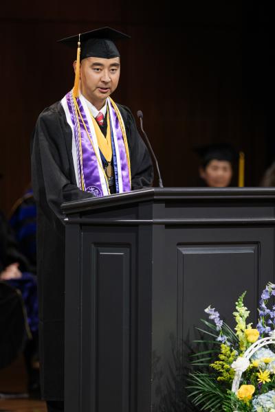 Wayne Nieh giving a speech at graduation.