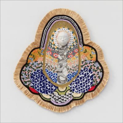 A multitude of patterns and textiles conjoin in a center point where a white sculpted face lies