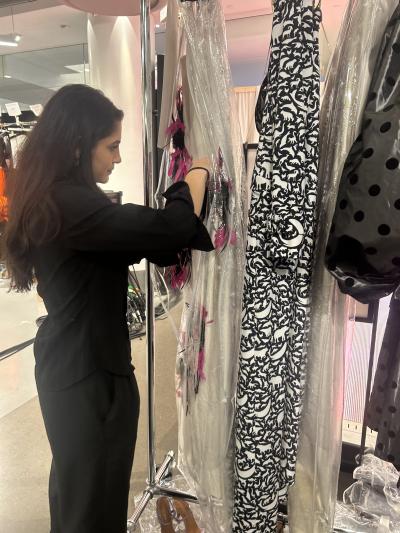 Honors student Sophia Daher working on a dress during her internship.