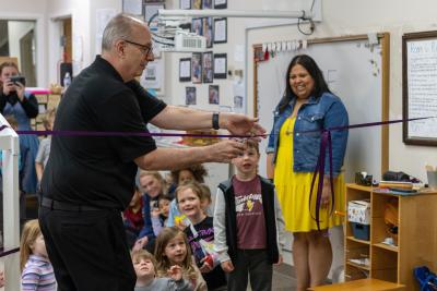 Kent City Mayor Jack Amrhein cuts the ribbon at the CDC's Lego City Grand Opening