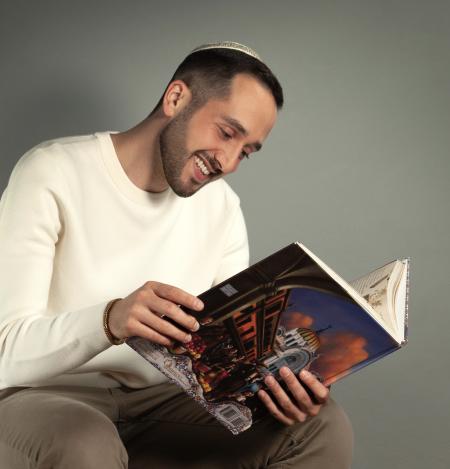 Kogan holding his book open and reading