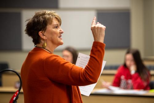 A professor teaching in a classroom.